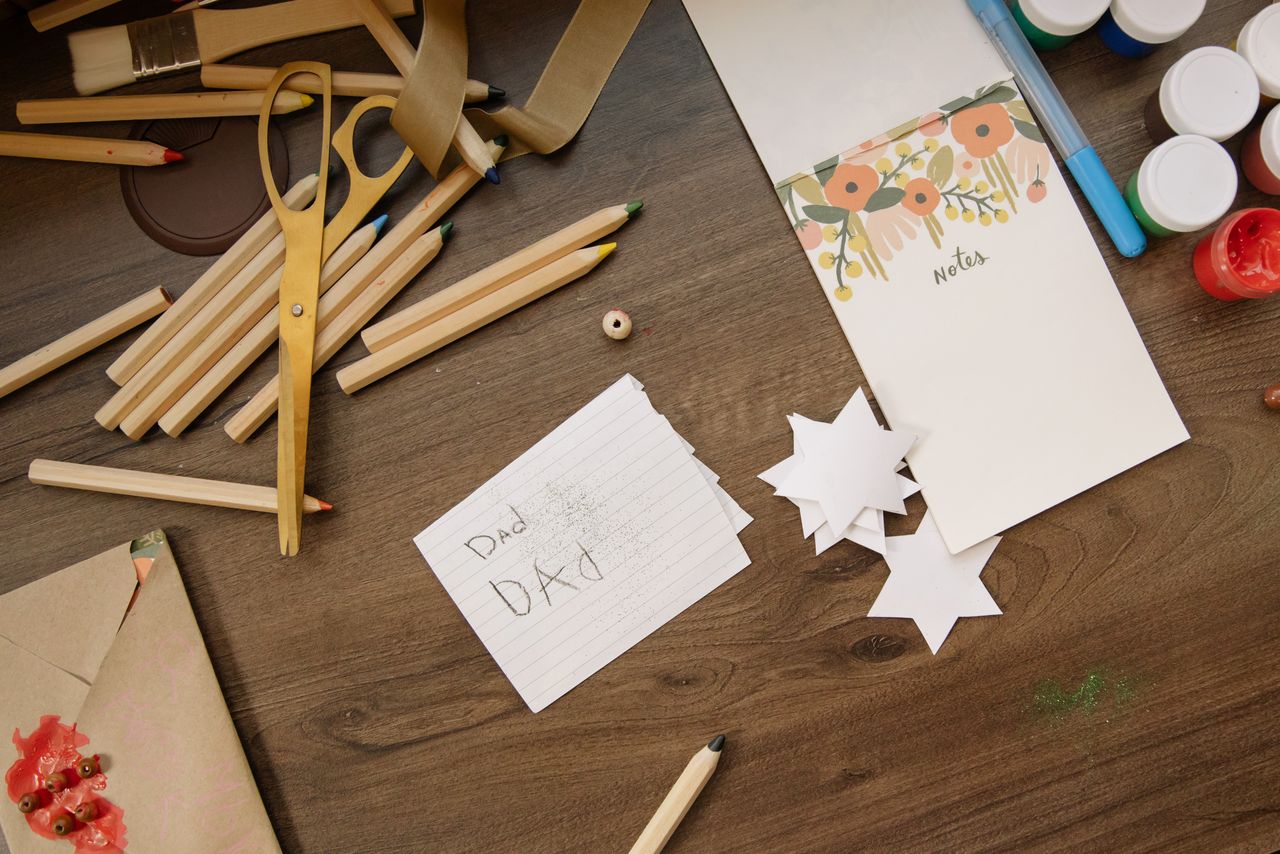 Crafting Captivating Headlines: Your awesome post title goes here Top view of art supplies including scissors, pencils, and handmade stars on a wooden surface.
